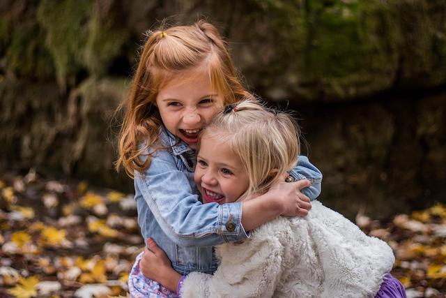 girl hugging another girl